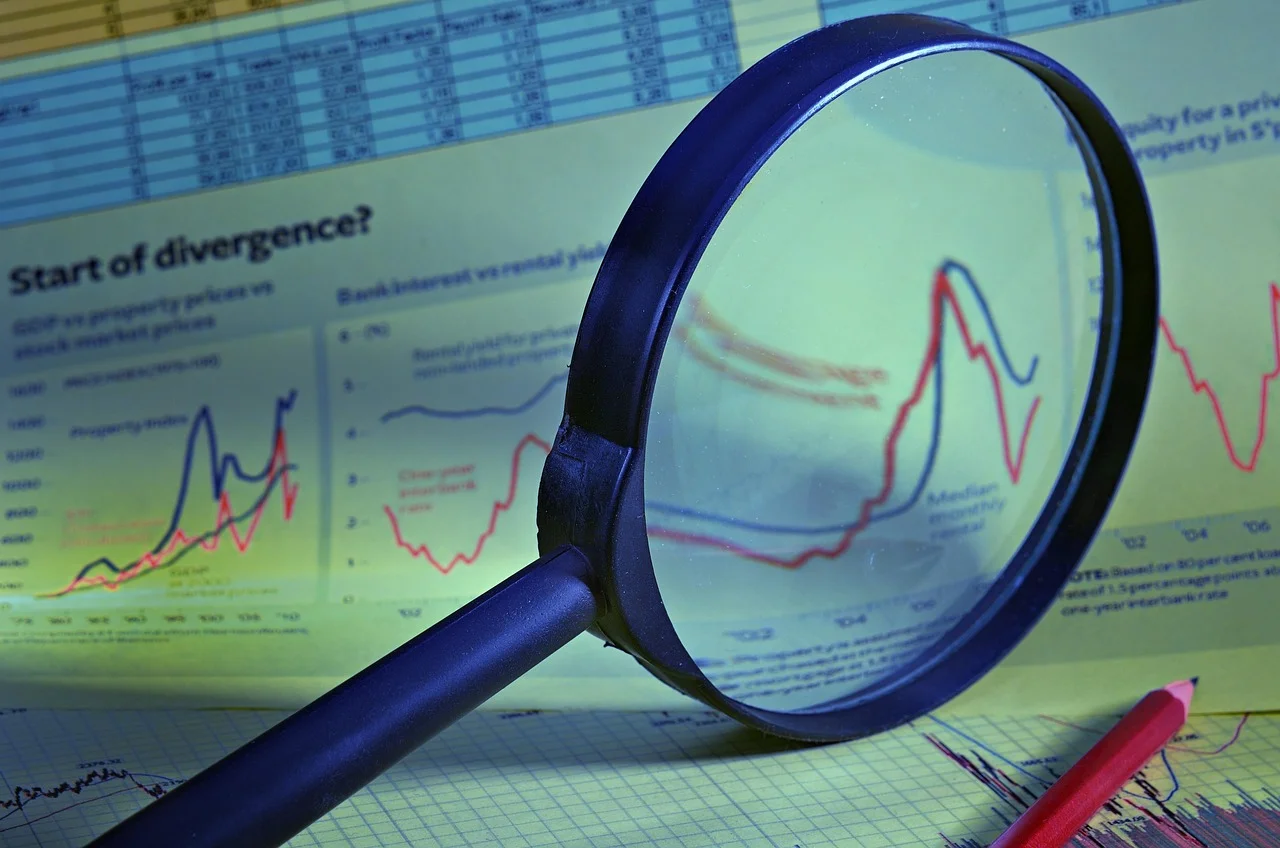 Magnifying glass resting on a printed analytics report on a desk