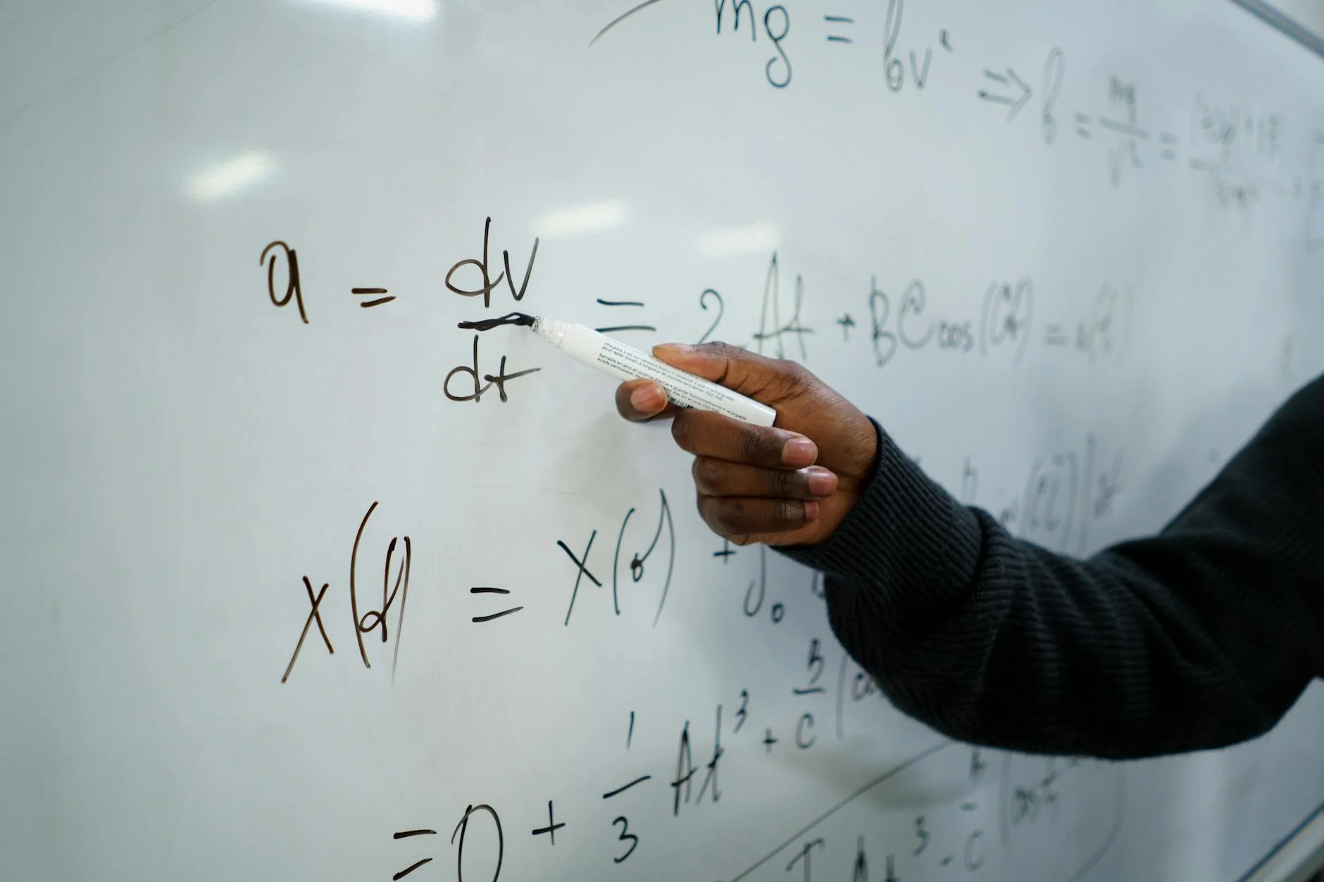 A chalkboard covered with handwritten formulas and diagrams