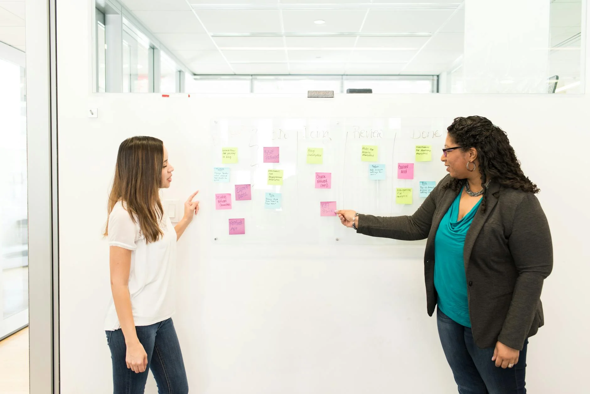 Whiteboard covered in sticky notes representing application architecture planning