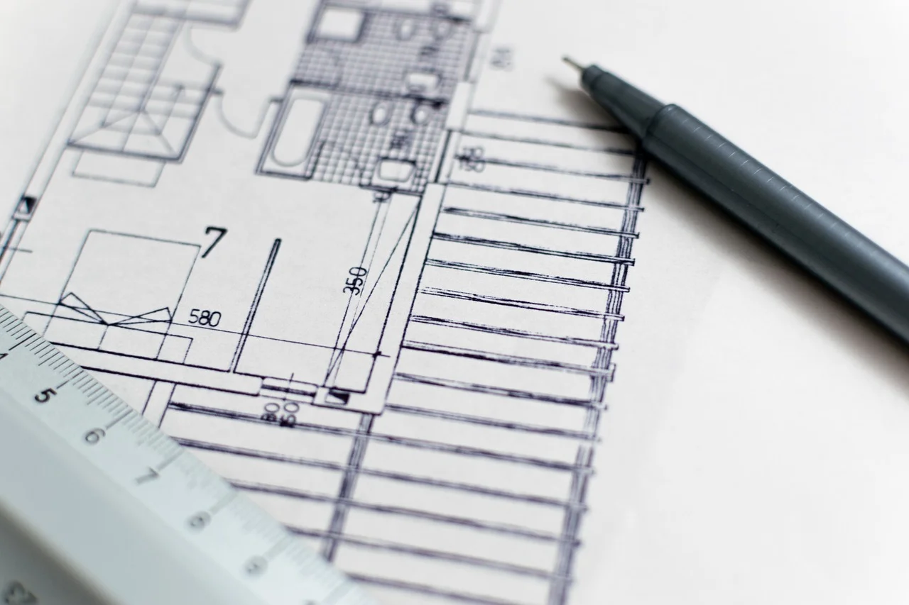Architecture blueprint with pencil and ruler representing structured technical planning and debt assessment