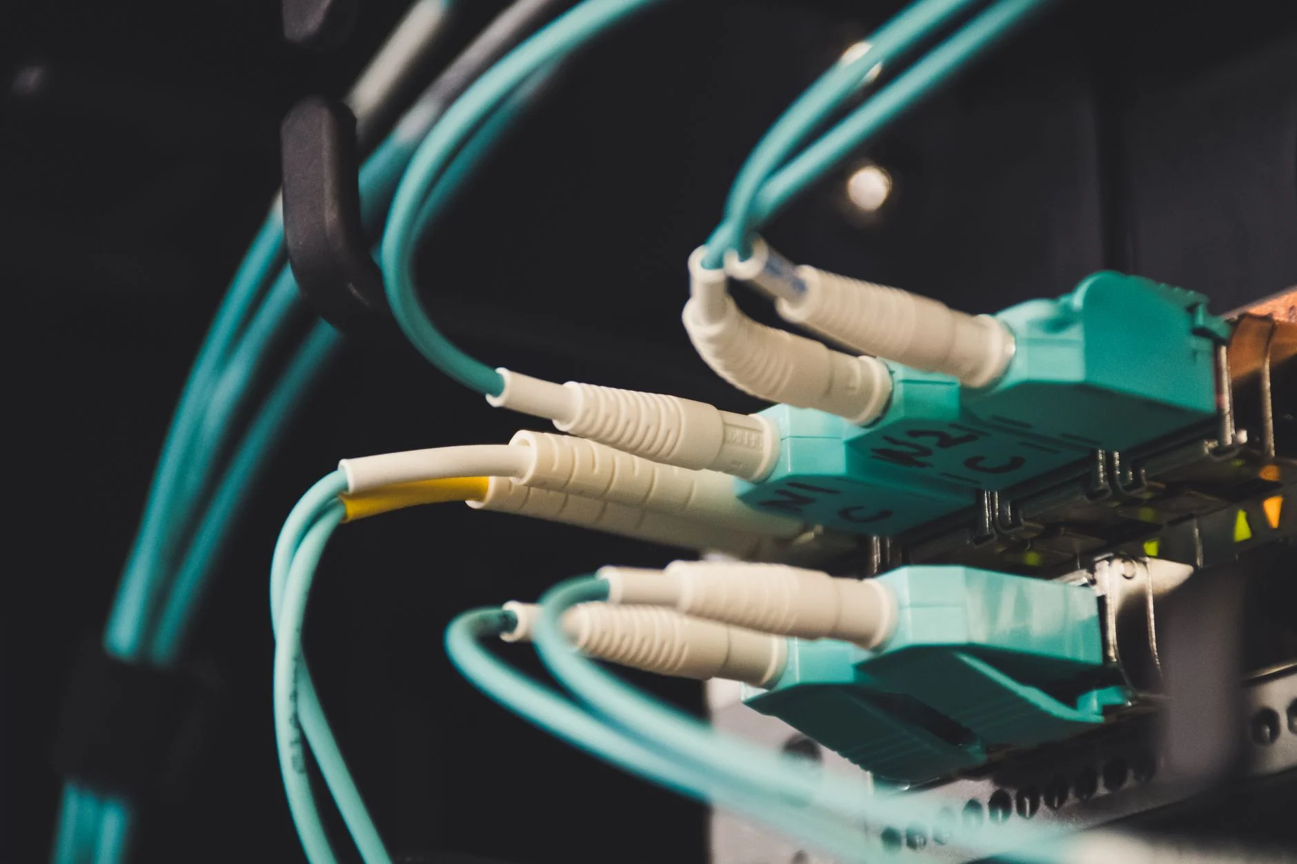 A close-up of glowing fiber optic strands representing data flow between systems