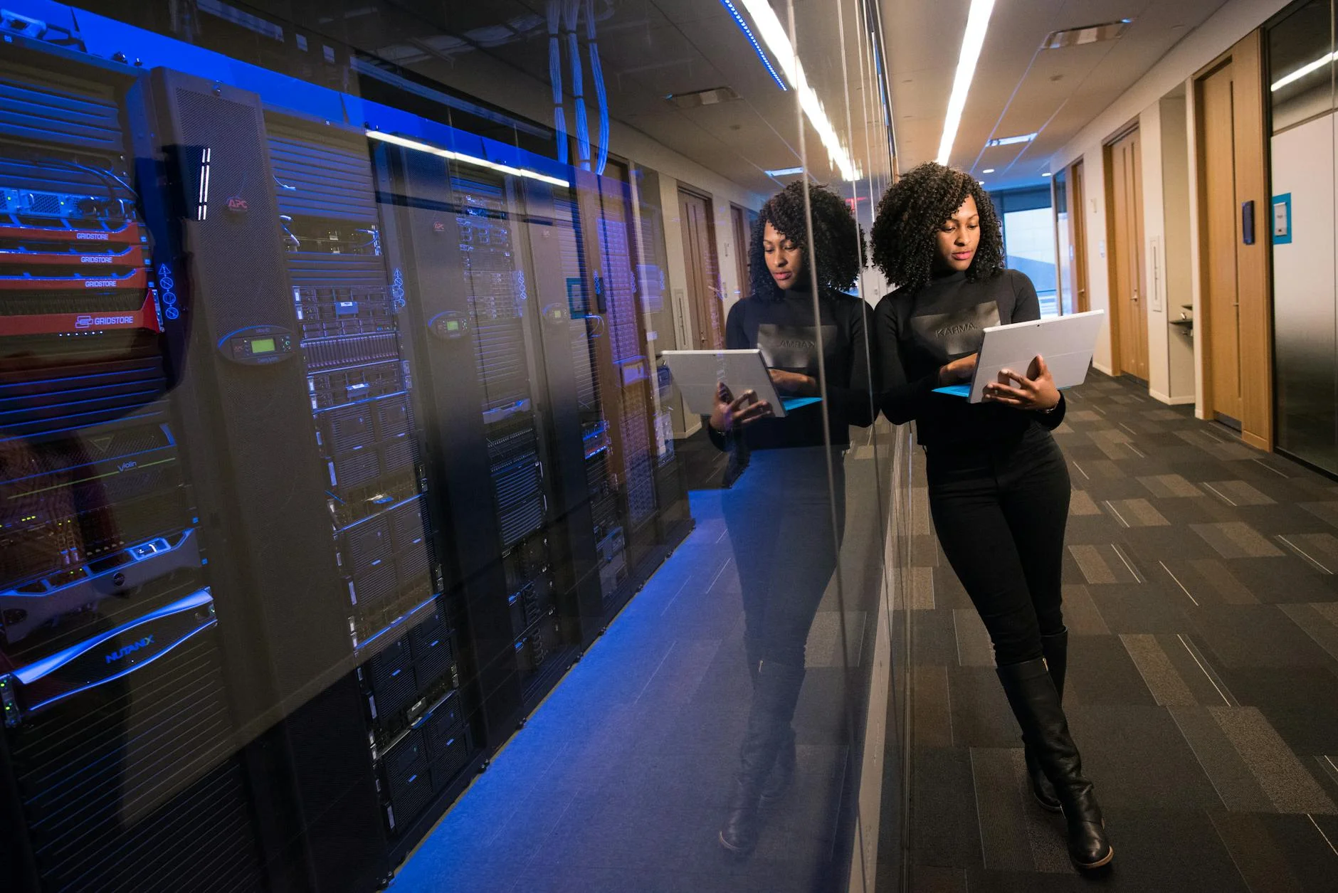 A long perspective shot down a data center hallway lined with server racks