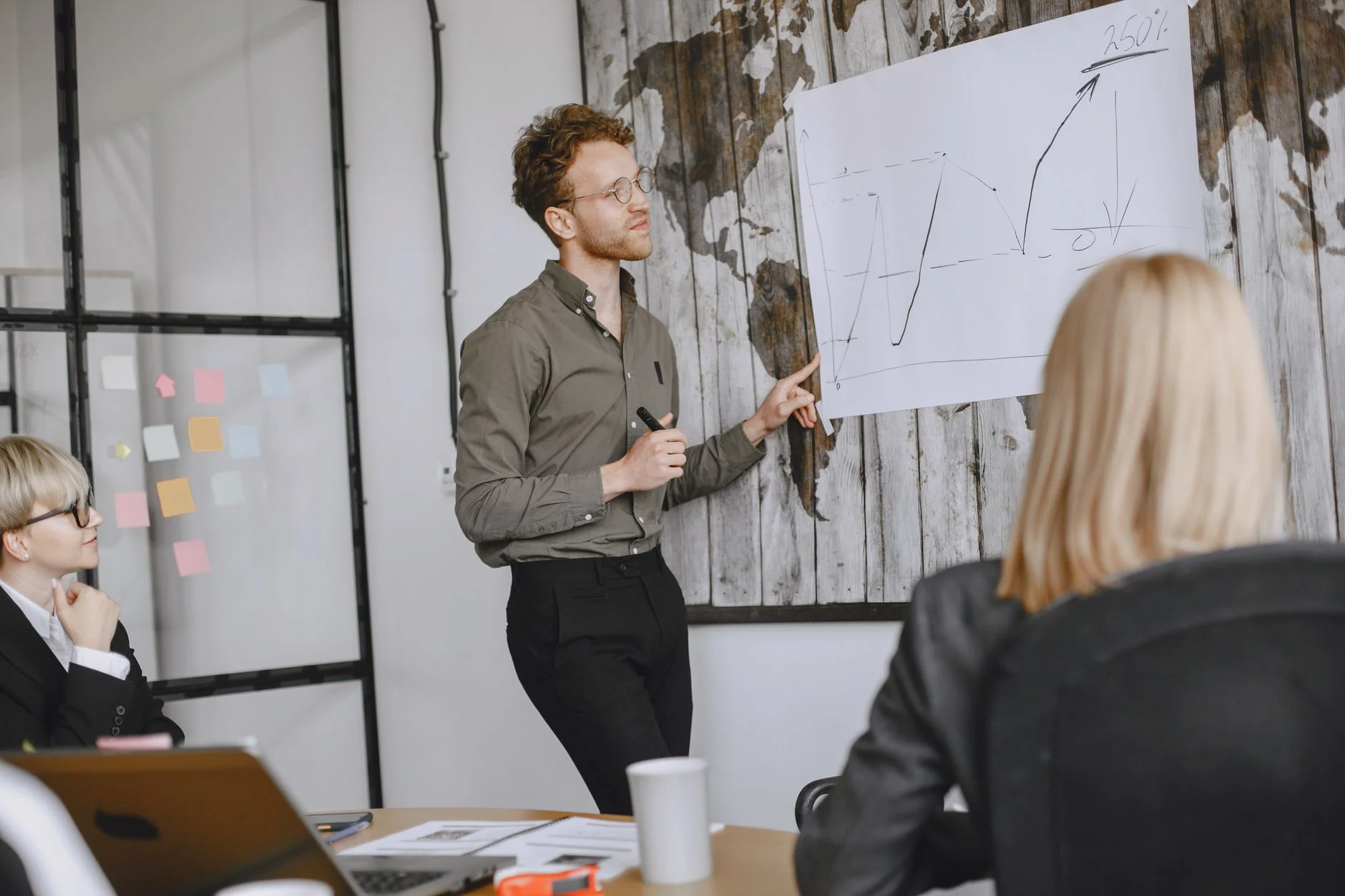 A boardroom whiteboard covered in strategic options, costs, and tradeoff arrows drawn in marker