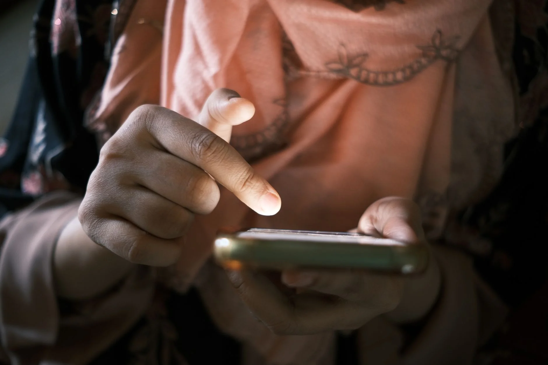 A smartphone in hand showing a file upload progress screen