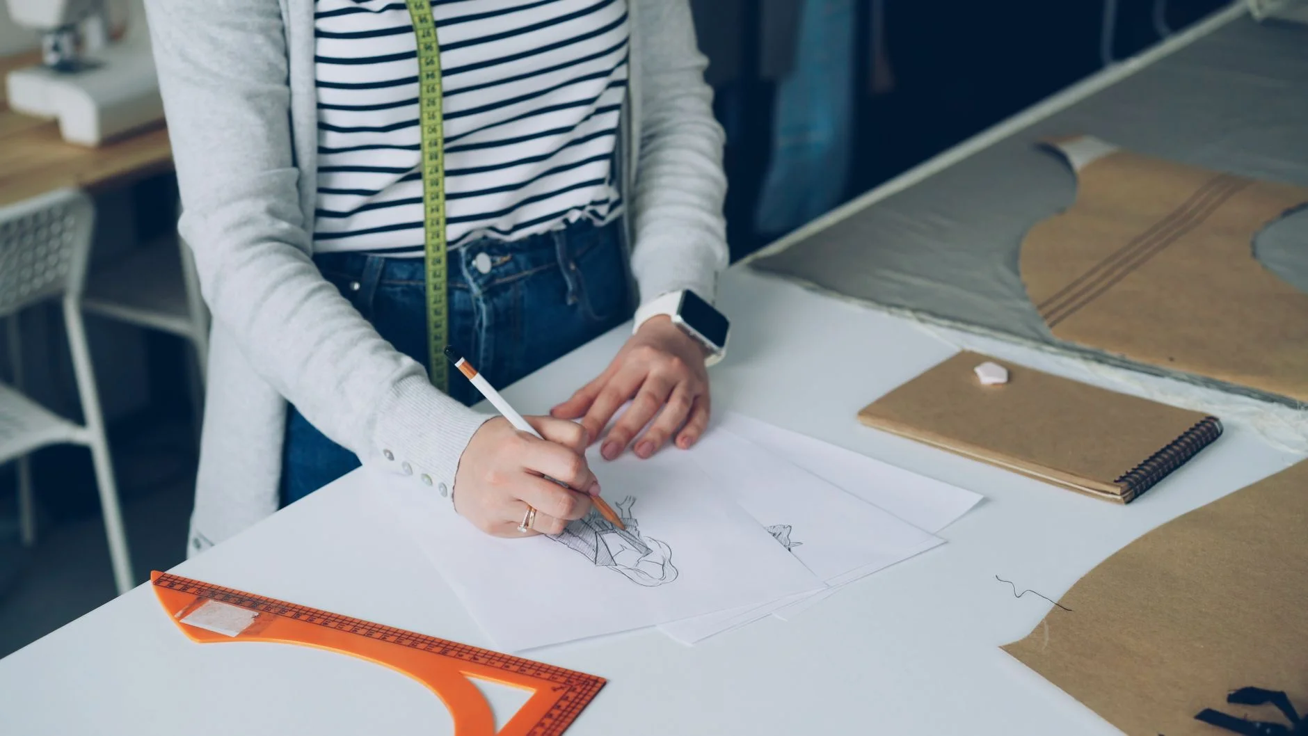 Designer at a wall covered with sketches and design notes