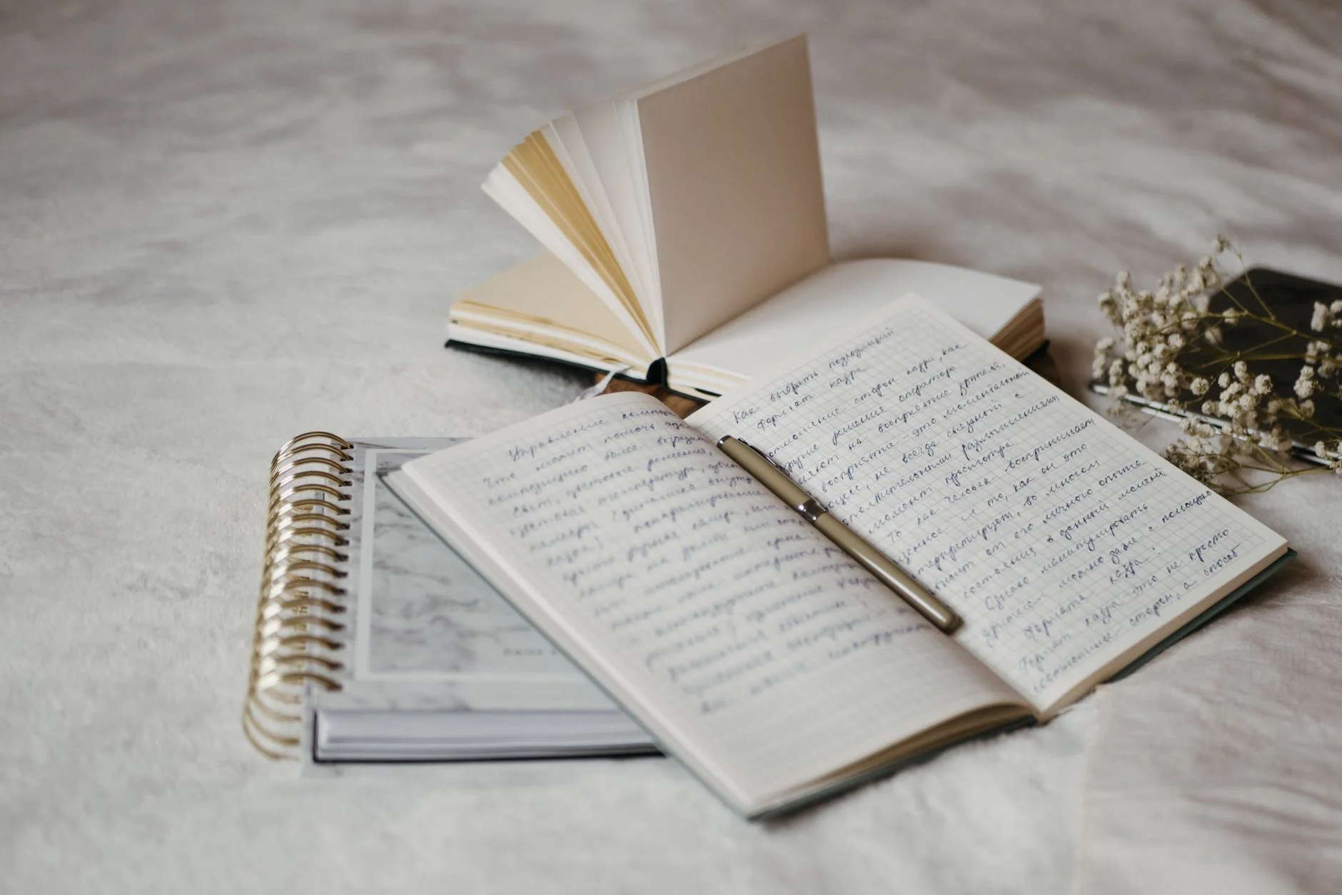 An open notebook with handwritten notes on a desk, used to plan an interface