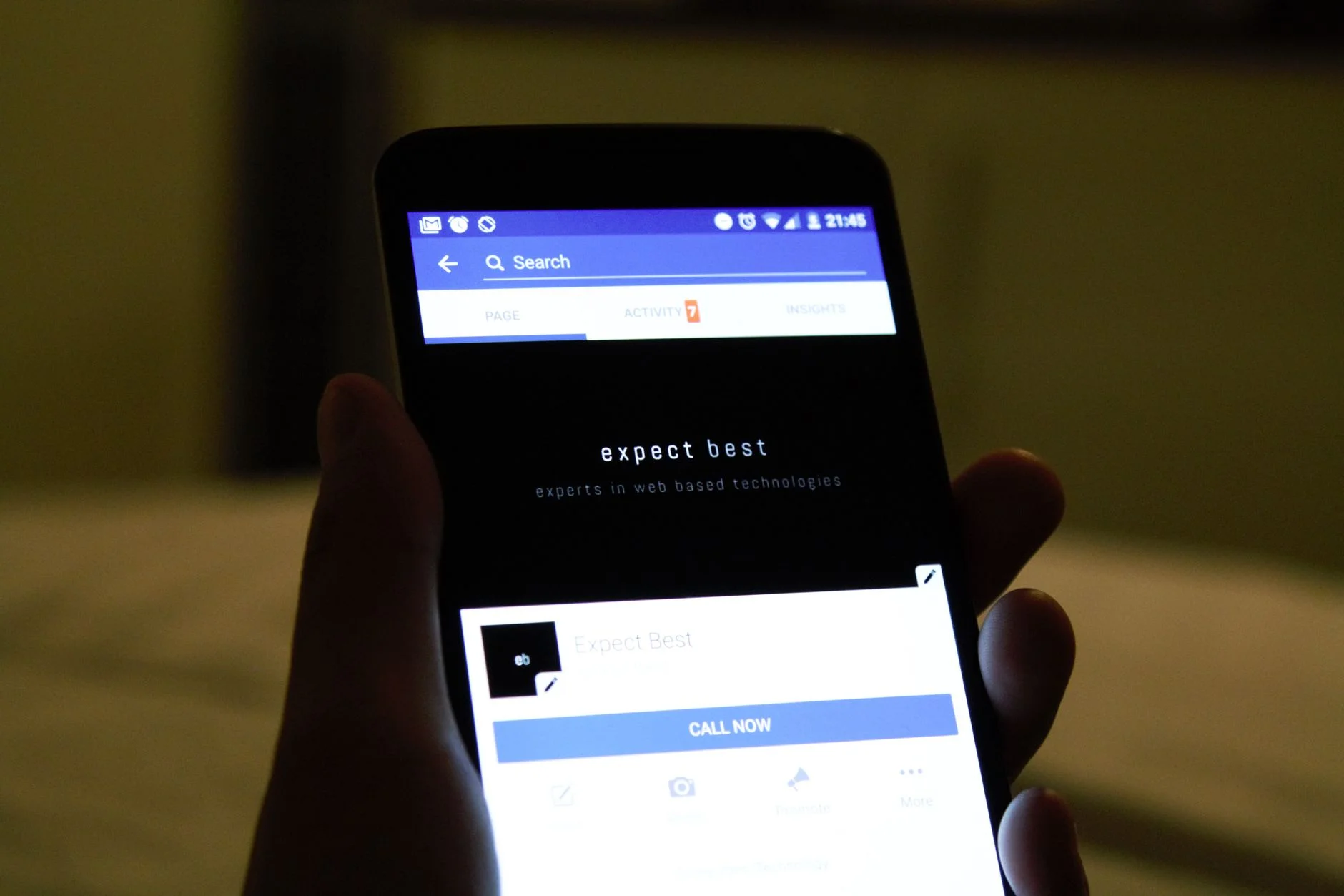 Close-up of a hand holding a smartphone with an app interface open