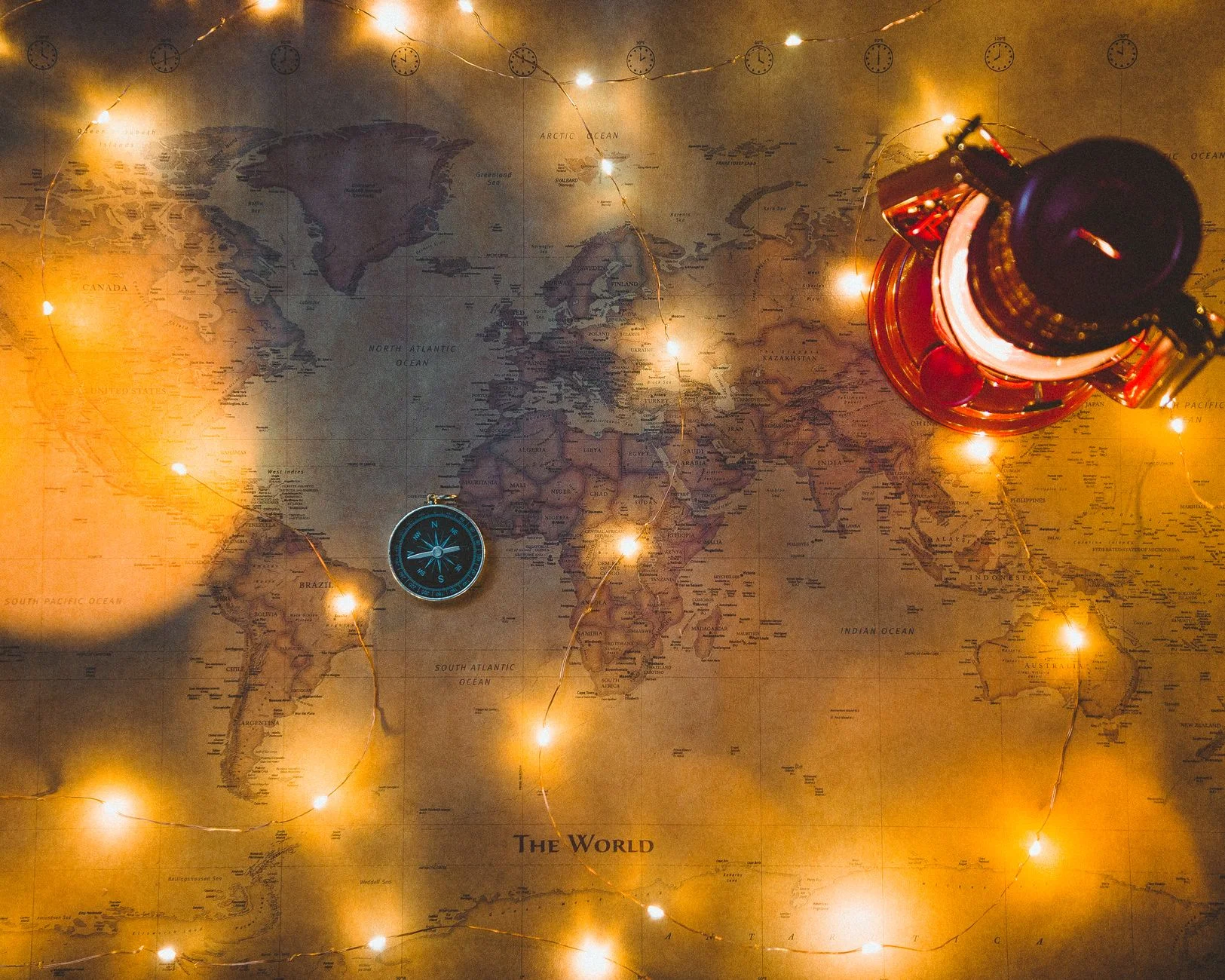 A compass resting on an open map at a desk, representing navigating a tangled path