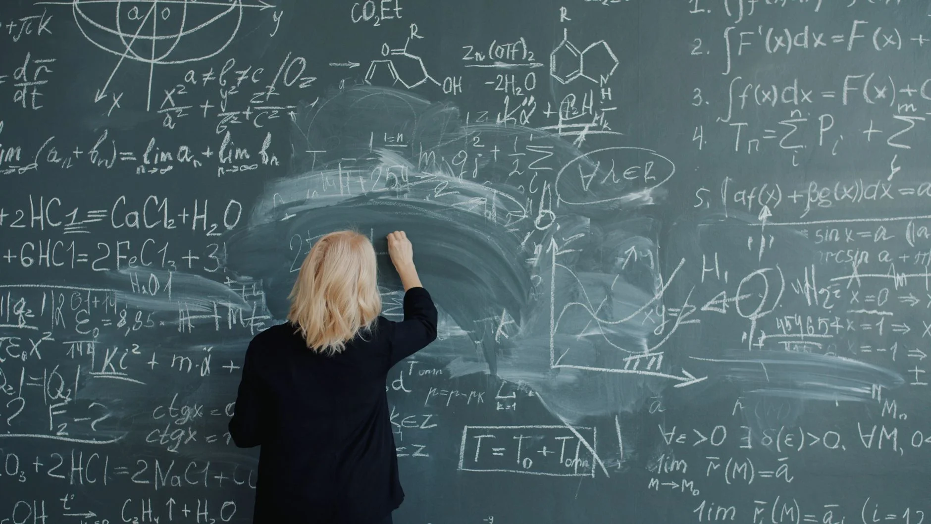 chalkboard covered in handwritten formulas and diagrams