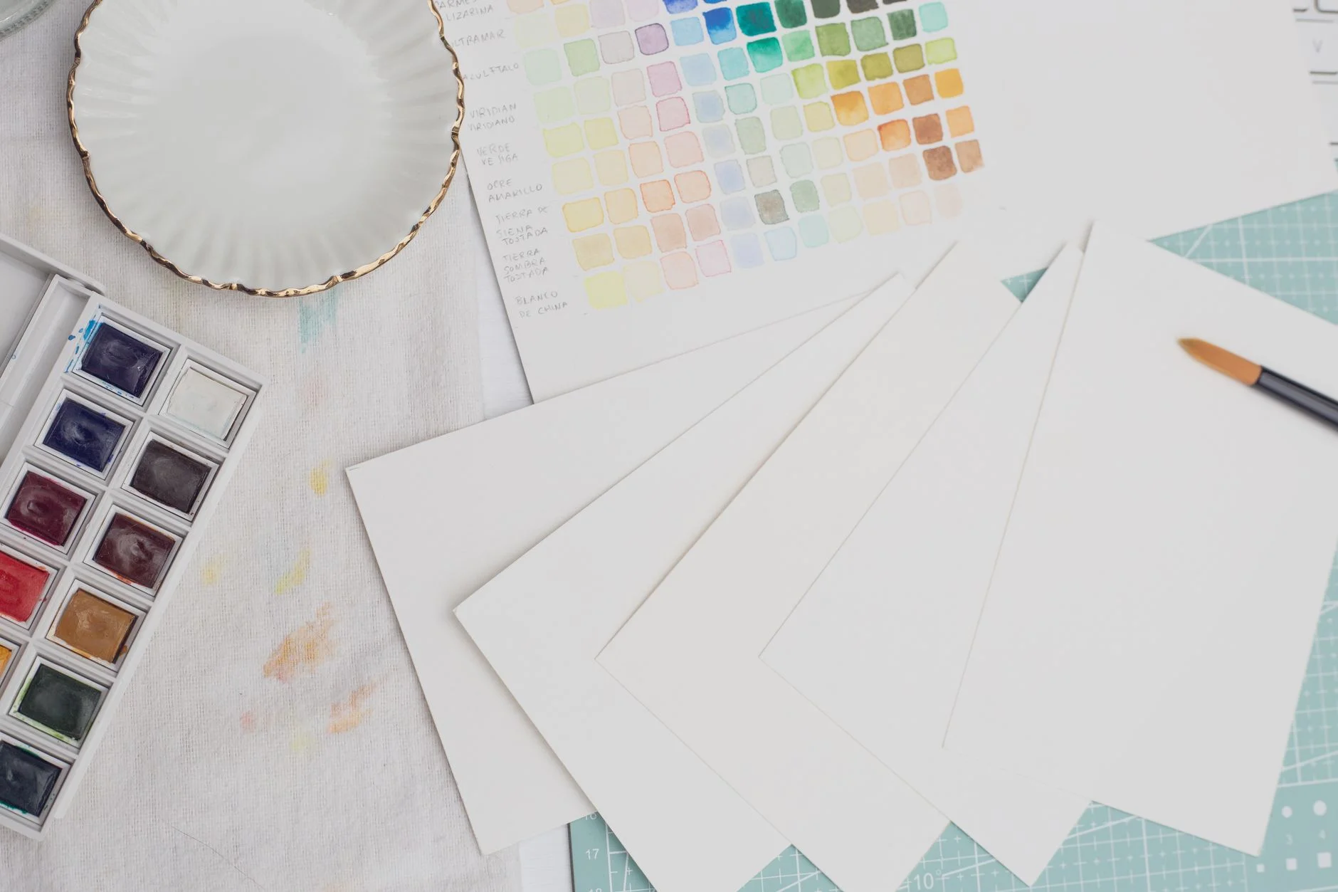 A row of color swatches and paint chips arranged by hue
