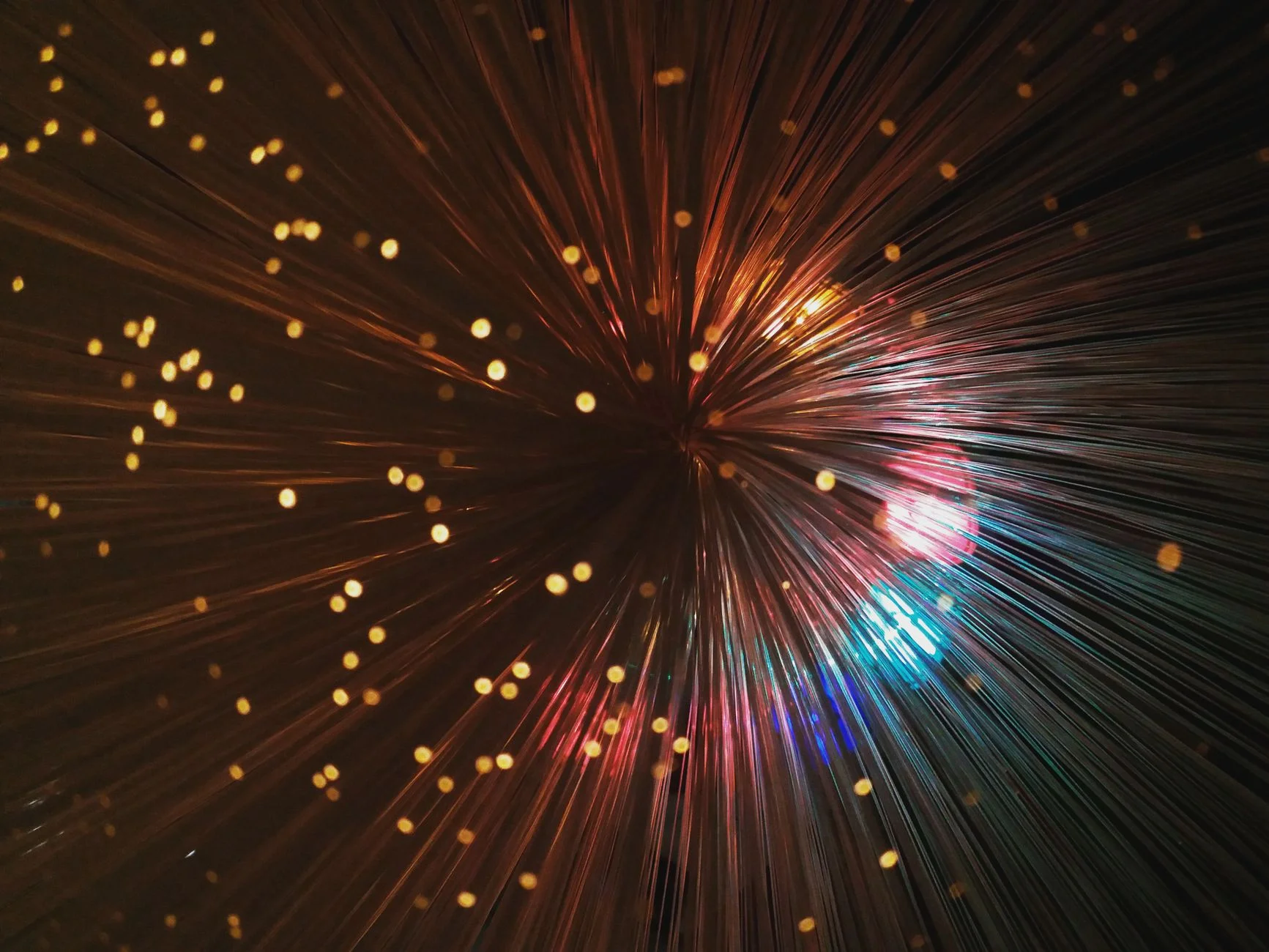 Glowing fiber optic light strands representing fast data delivery