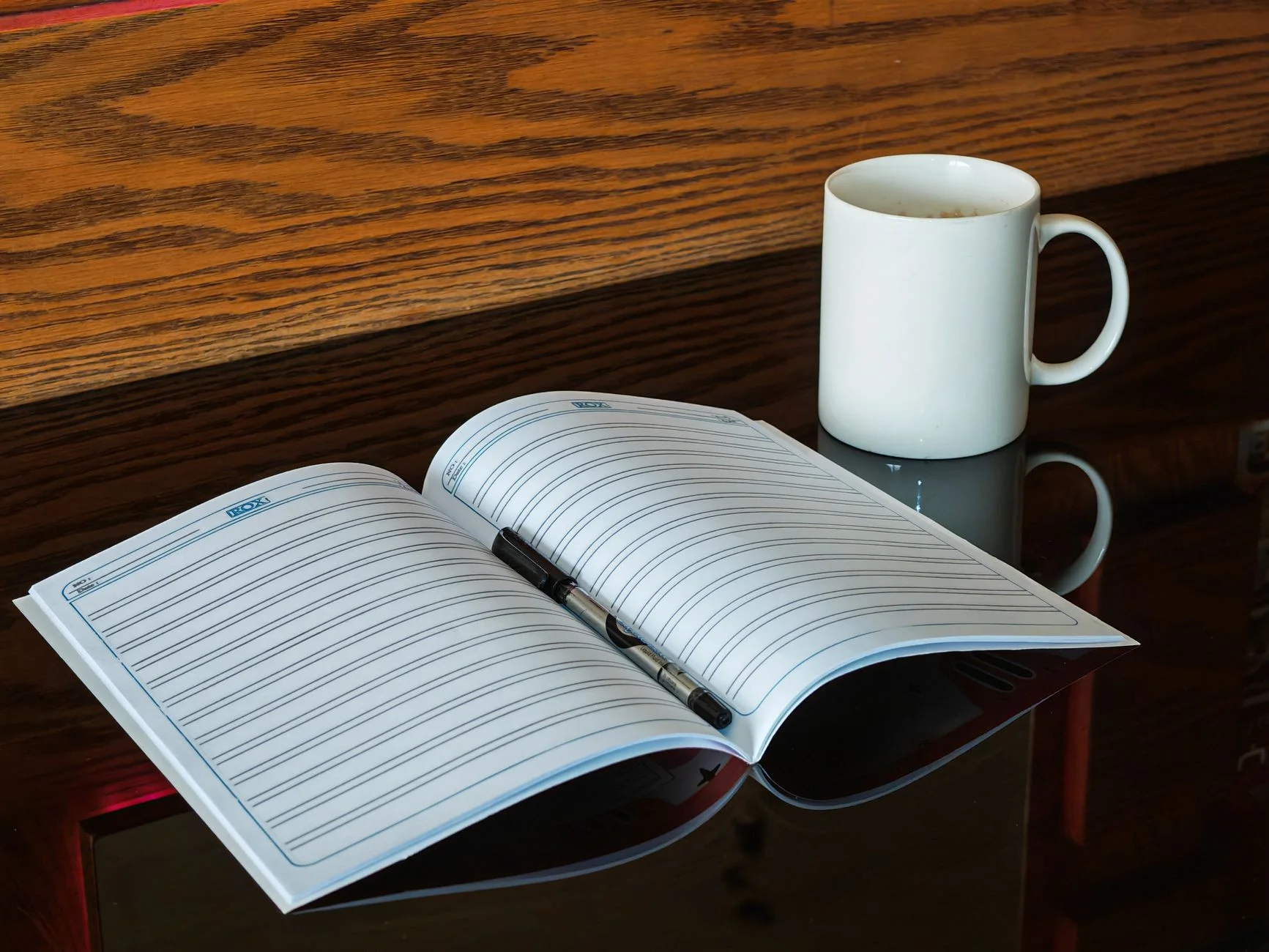 An open notebook with handwritten notes on a desk