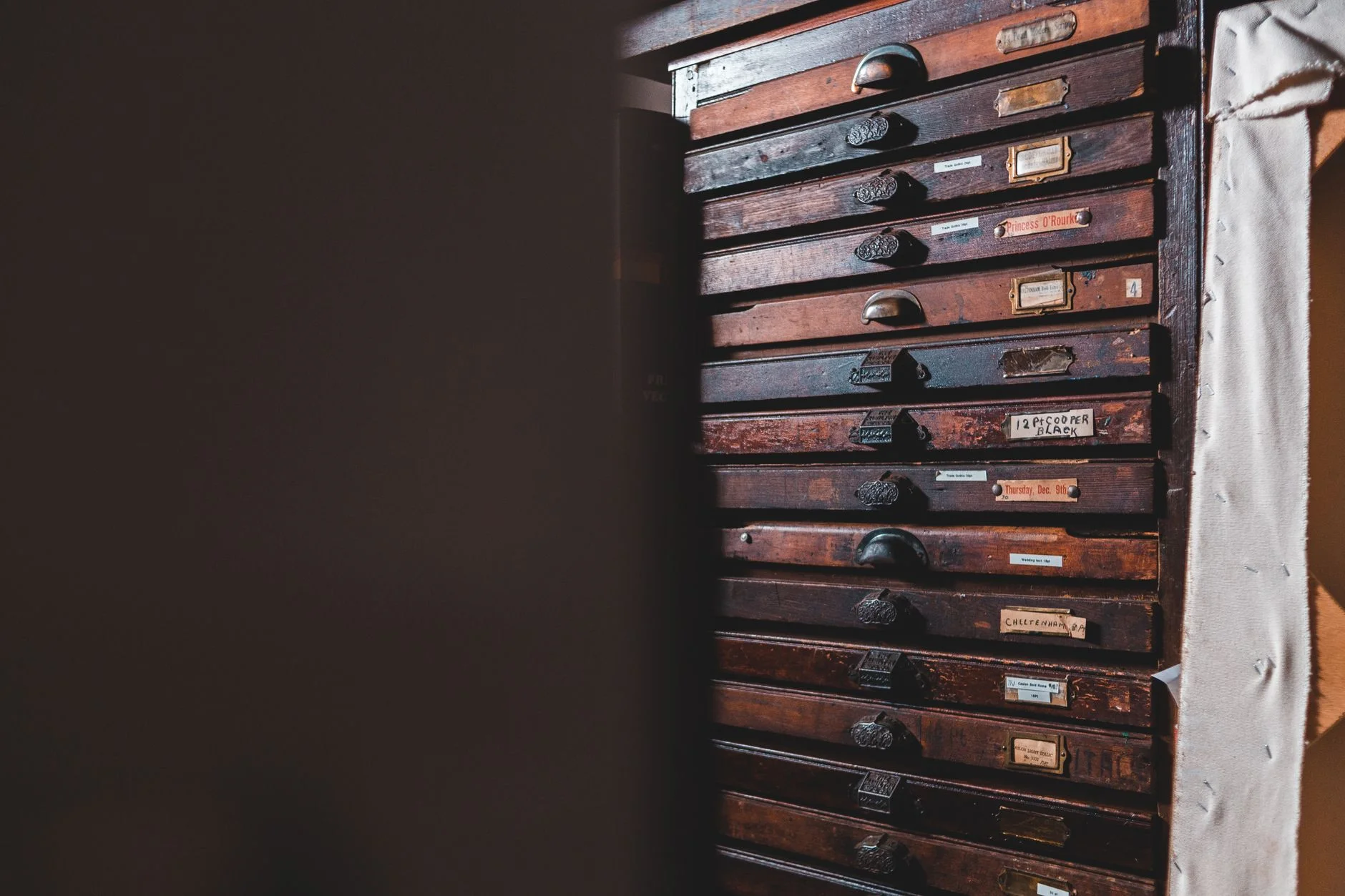 Rows of locked archive cabinet drawers in a records room