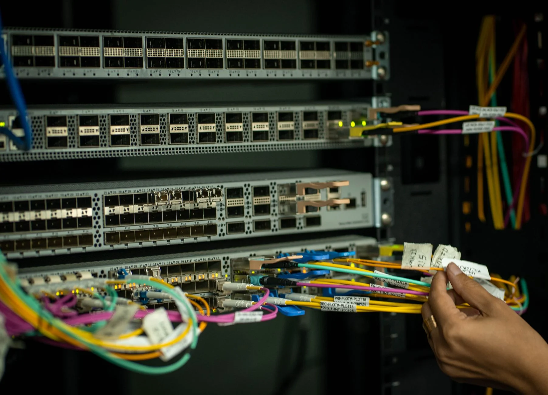 A patch panel with neatly labeled network cables in a server room
